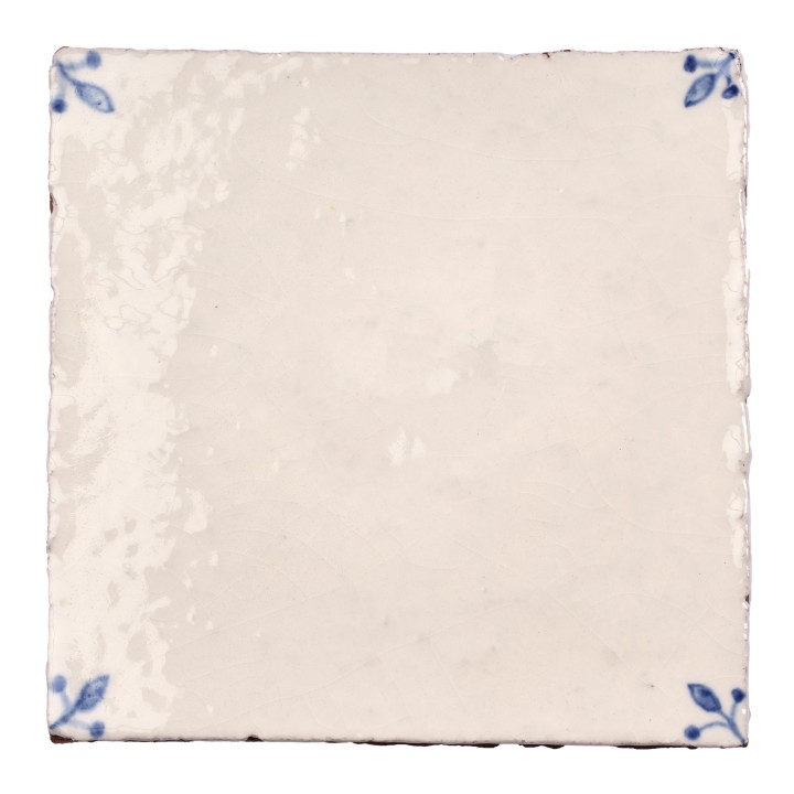 Cut out image of white tile with handpainted delft blue corner illustrations