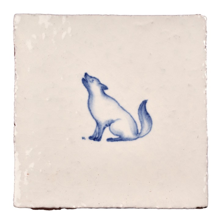 Cut out image of white tile with handpainted delft blue wolf illustration