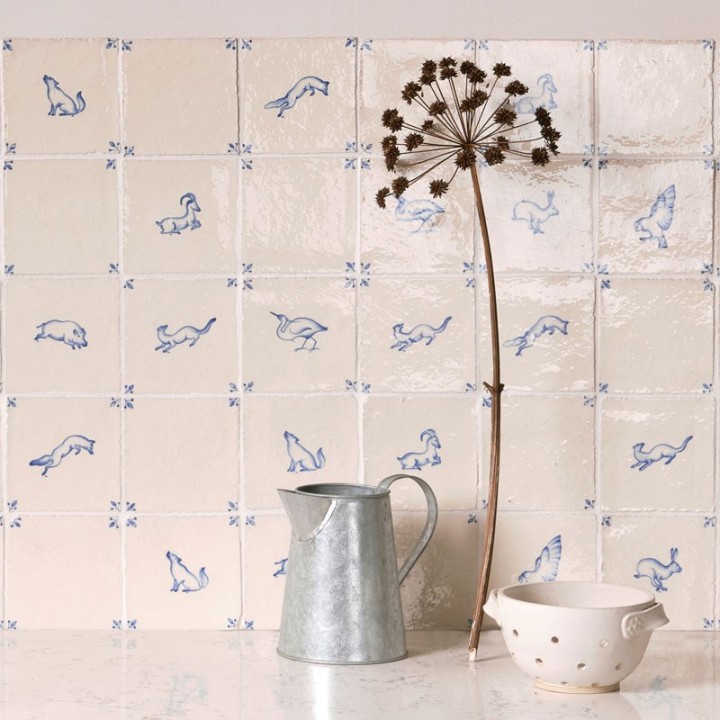 Close up of handpainted delft wall tiles with blue animal illustrations