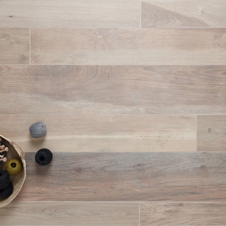 Oak wood effect porcelain small floor tiles in varying sizes with a bowl of yarn