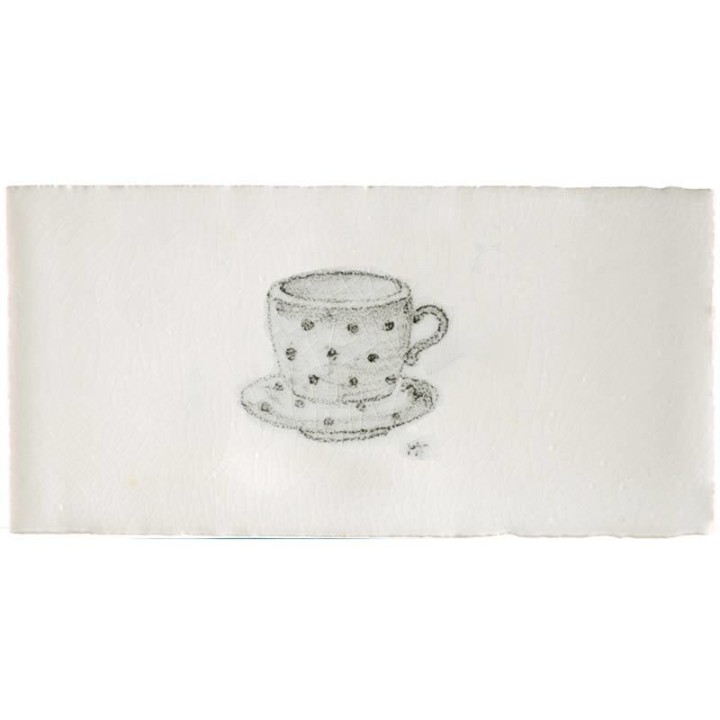 Cut out of a metro tile with a cup and saucer illustration in a charcoal style
