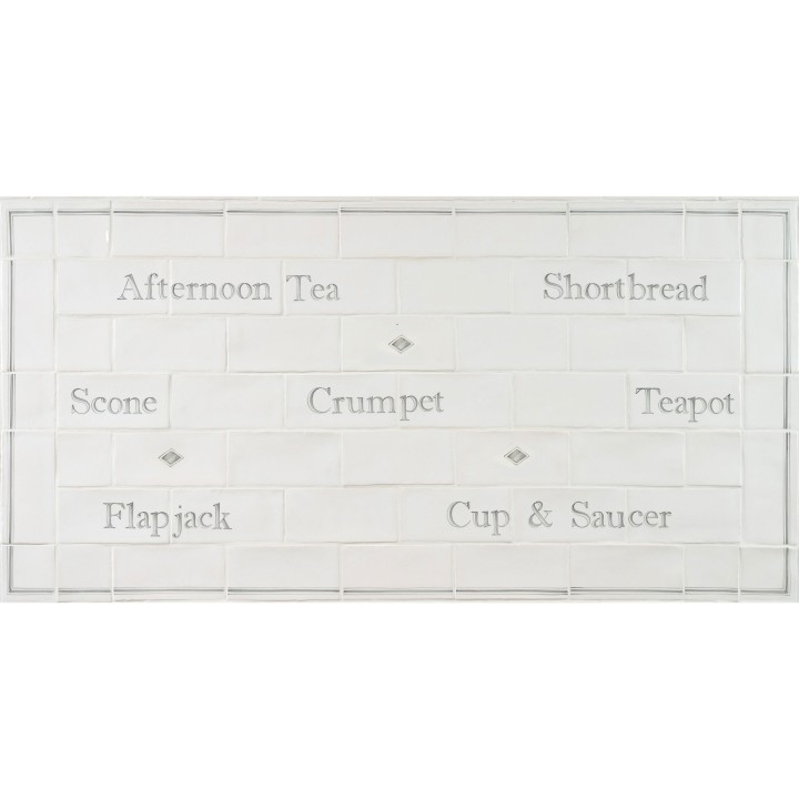 Word tile splashback panel with afternoon tea words like crumpet, teapot and scones framed with a border and diamond tiles