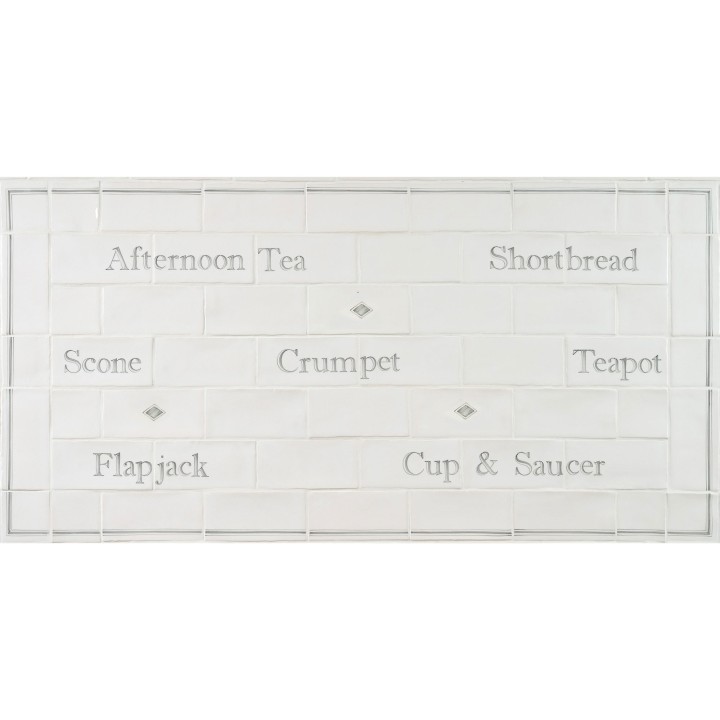 Word tile splashback panel with afternoon tea words like crumpet, teapot and scones framed with a border and diamond tiles