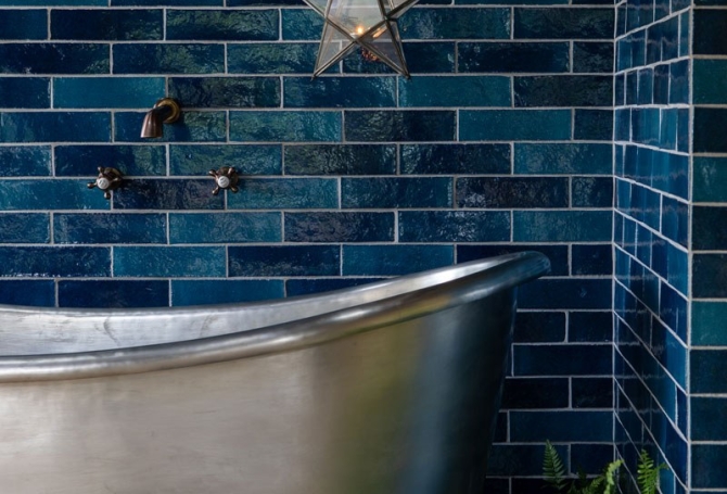 Dark and vibant blue zellige and bejmat effect wall tiles in an outdoor bathroom