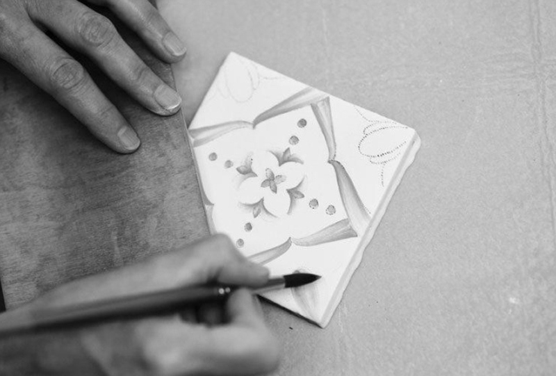 Ana tile being handpainted in majolica style