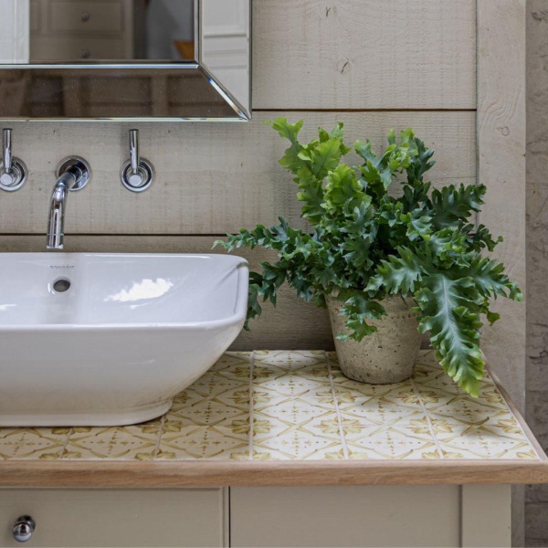 Mediterranean inspired Ana square tiles in Amber add detail to this beautiful washstand at Emma Sims Hilditch's Wiltshire home.