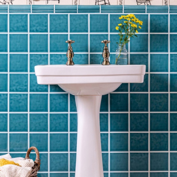 Chroma Romany Green wall tiles with bolection dado border piece behind bathroom sink