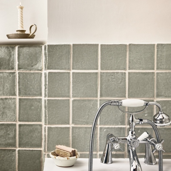 Pale green handmade artisanal square tiles in a bathroom
