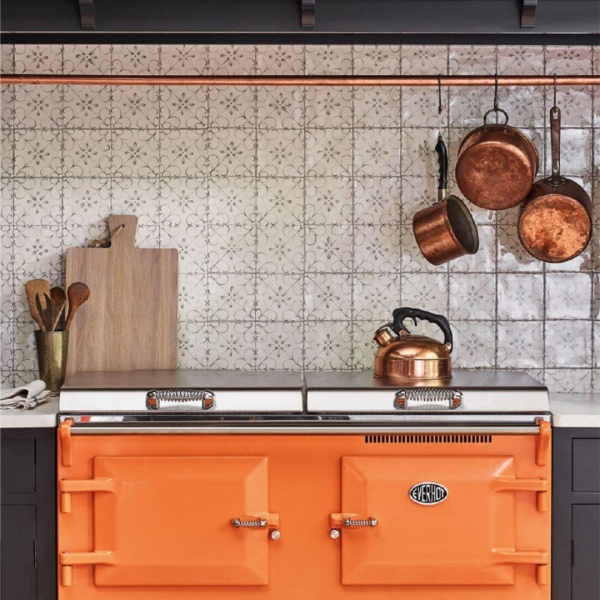 Hand painted, patterned tiles above a range cooker.