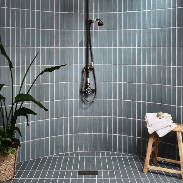 Blue green skinny metro brick tiles in a shower