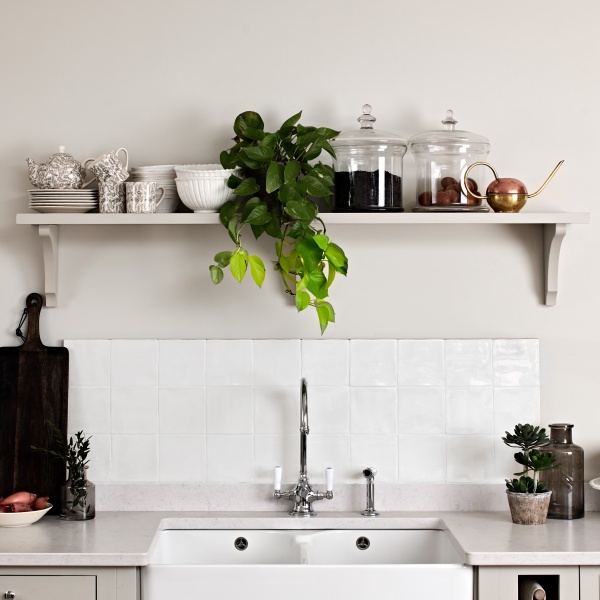 White square tiles above a kitchen sink