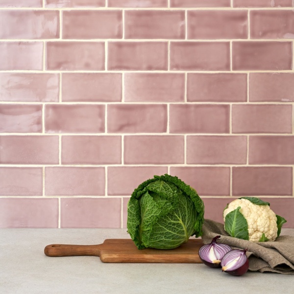 A kitchen sideboard with pink medium brick tile