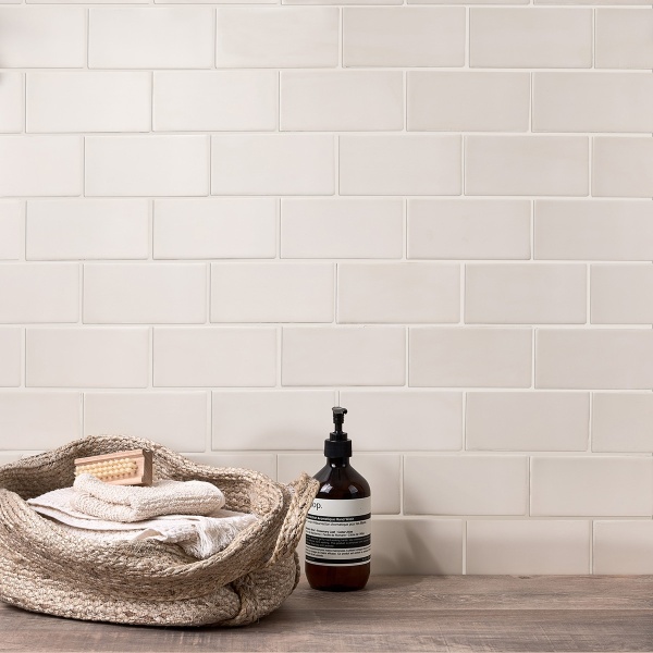 A bathroom shelf with neutral toned medium brick matt tiles