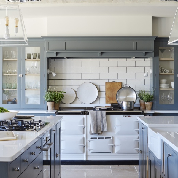 A beautiful white kitchen with long brick white tiles above the range cooker.