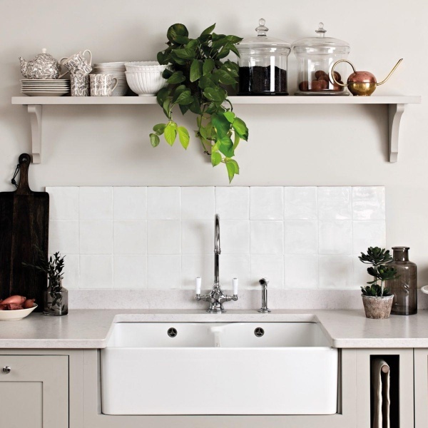 A crisp, clean kitchen with white square tiles.