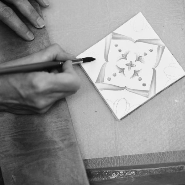 Ana tile being hand painted by artist