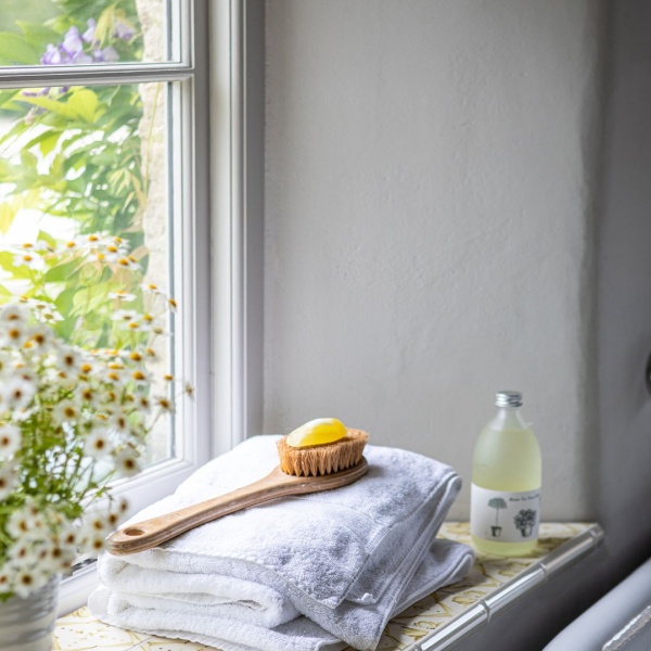 Hand painted Ana tiles in ﻿Amber add detail and charm to the window ledge in this bathroom at Emma Sims Hilditch's Wiltshire home.