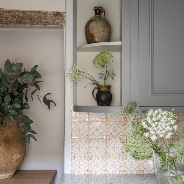 Ana burnt orange tiles laid in a grid layout in a utility room