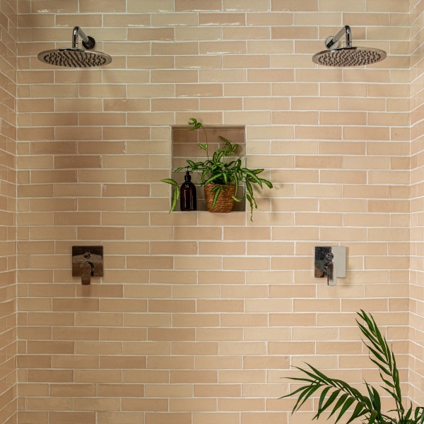 In this beautiful statement shower area, Uist skinny metro brick tiles from our Isles collection are finished with beige grout.