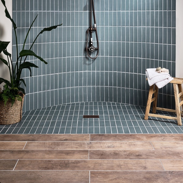Our Weathered Oak porcelain planks in Biscuit are a beautiful accompaniment to these Coldharbour Green skinny metro tiles from our Marlborough Matts collection.