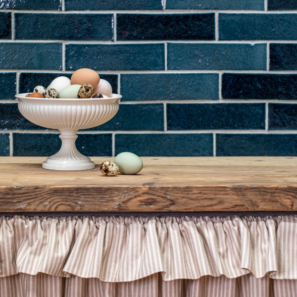 A kitchen featuring handmade skinny metro brick tiles in dark blue